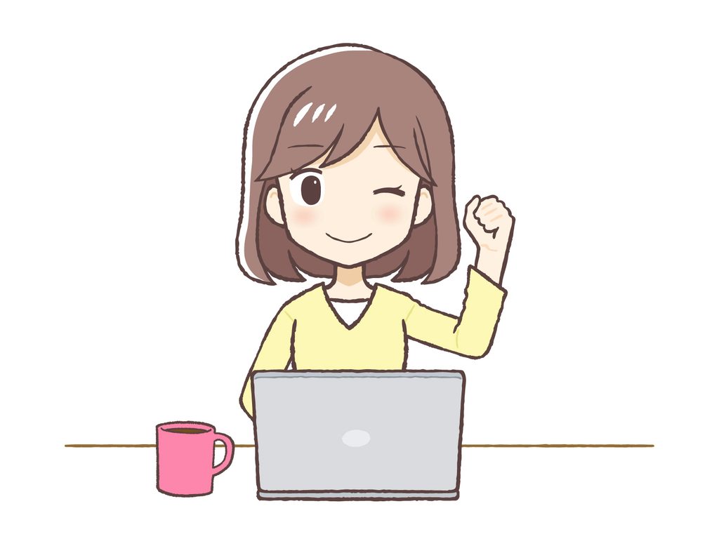 パソコンの前で笑顔でいる女性の画像